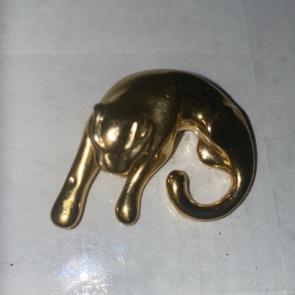 14k gold hallow panther with a small baby tooth crushing on his front paw.